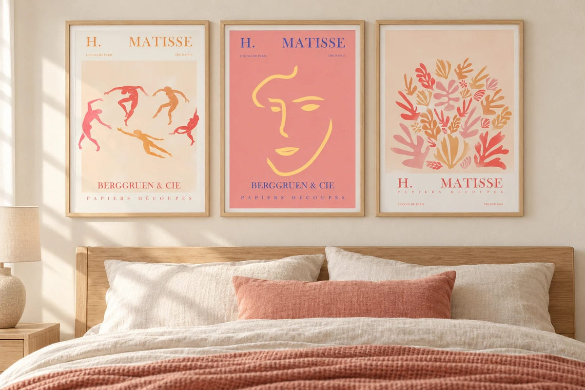 Dancing figures and leaf prints above a light bed with coral textiles.