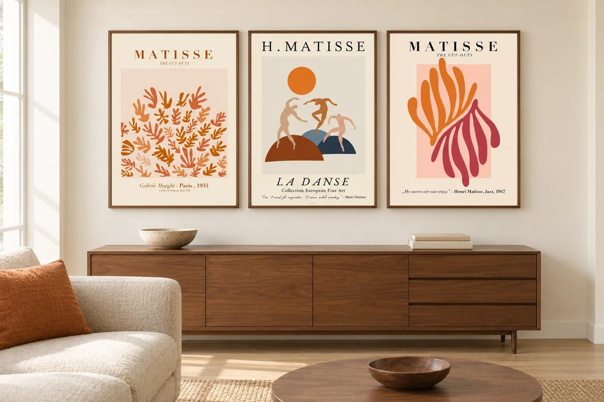 Warm prints above a walnut dresser in a living room.