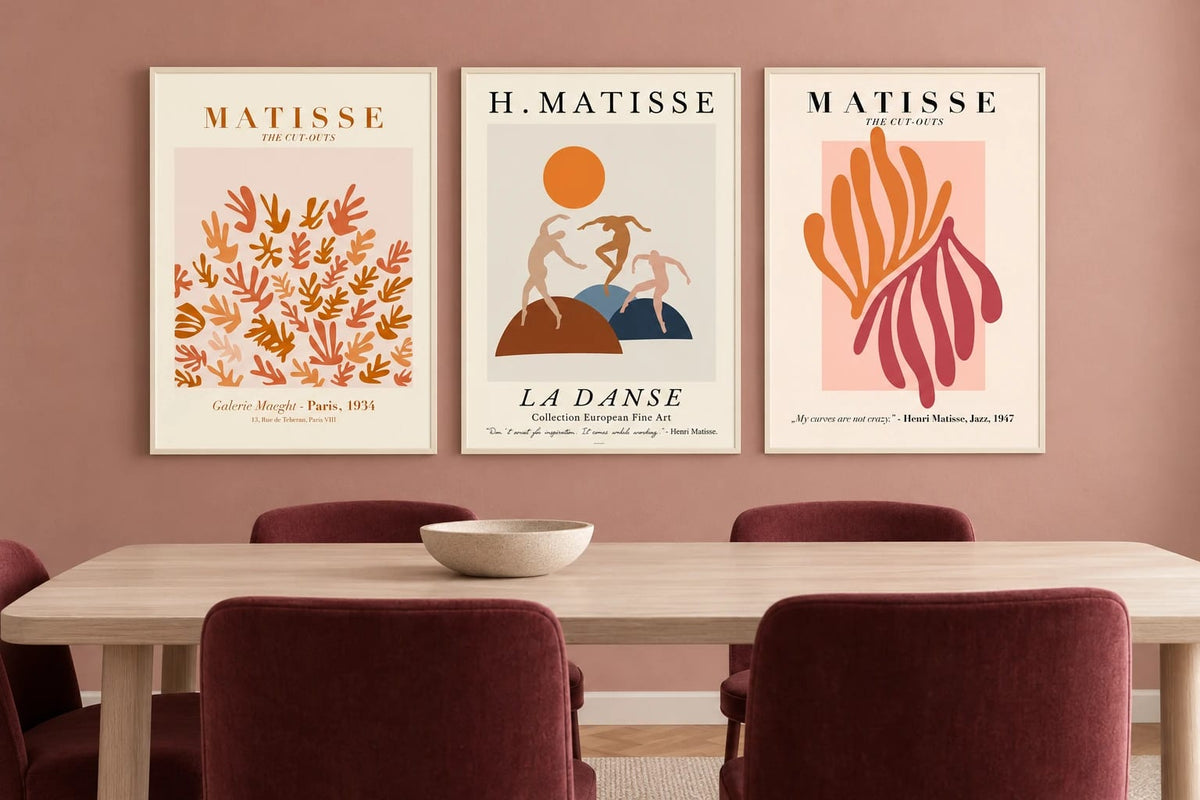 Three abstract prints in a terracotta dining room.