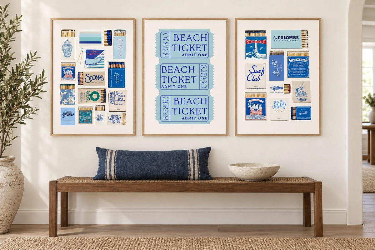 Three blue prints above a bench in a light entryway.