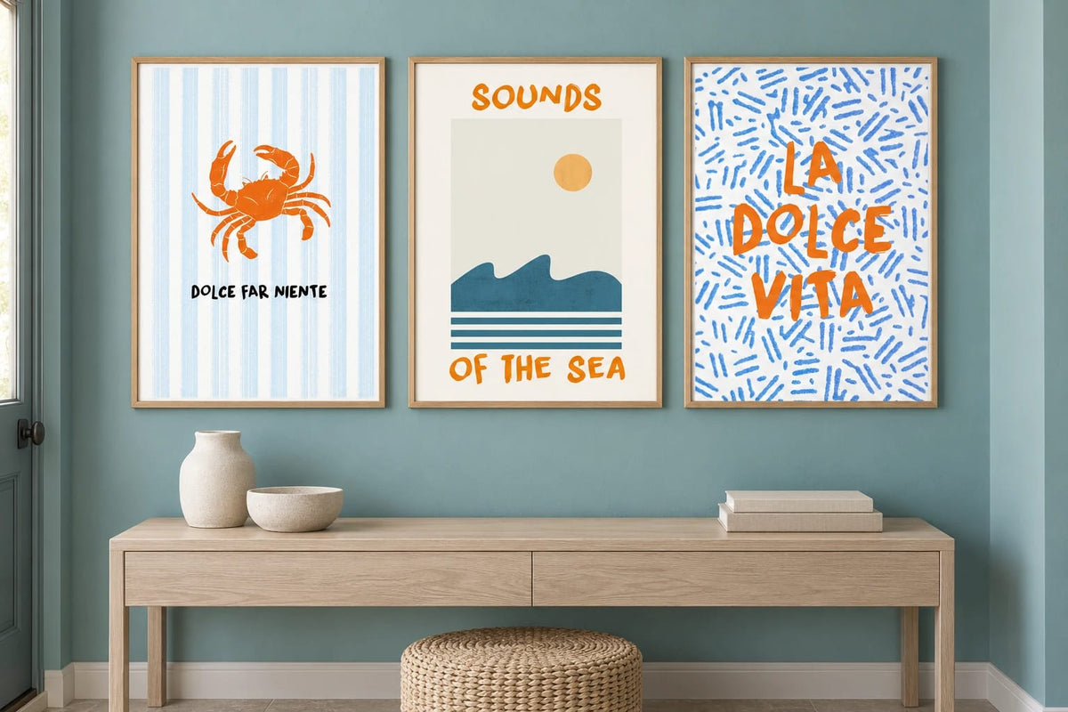 Coastal triptych above an entryway console against turquoise.