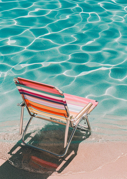 a striped chair beside the water