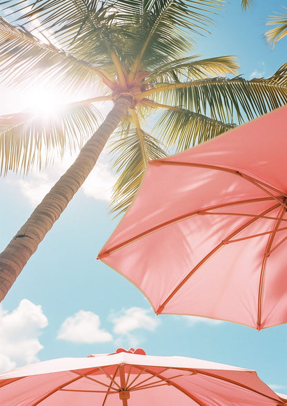 a palm, blue sky, sun flare, and two pink umbrellas.