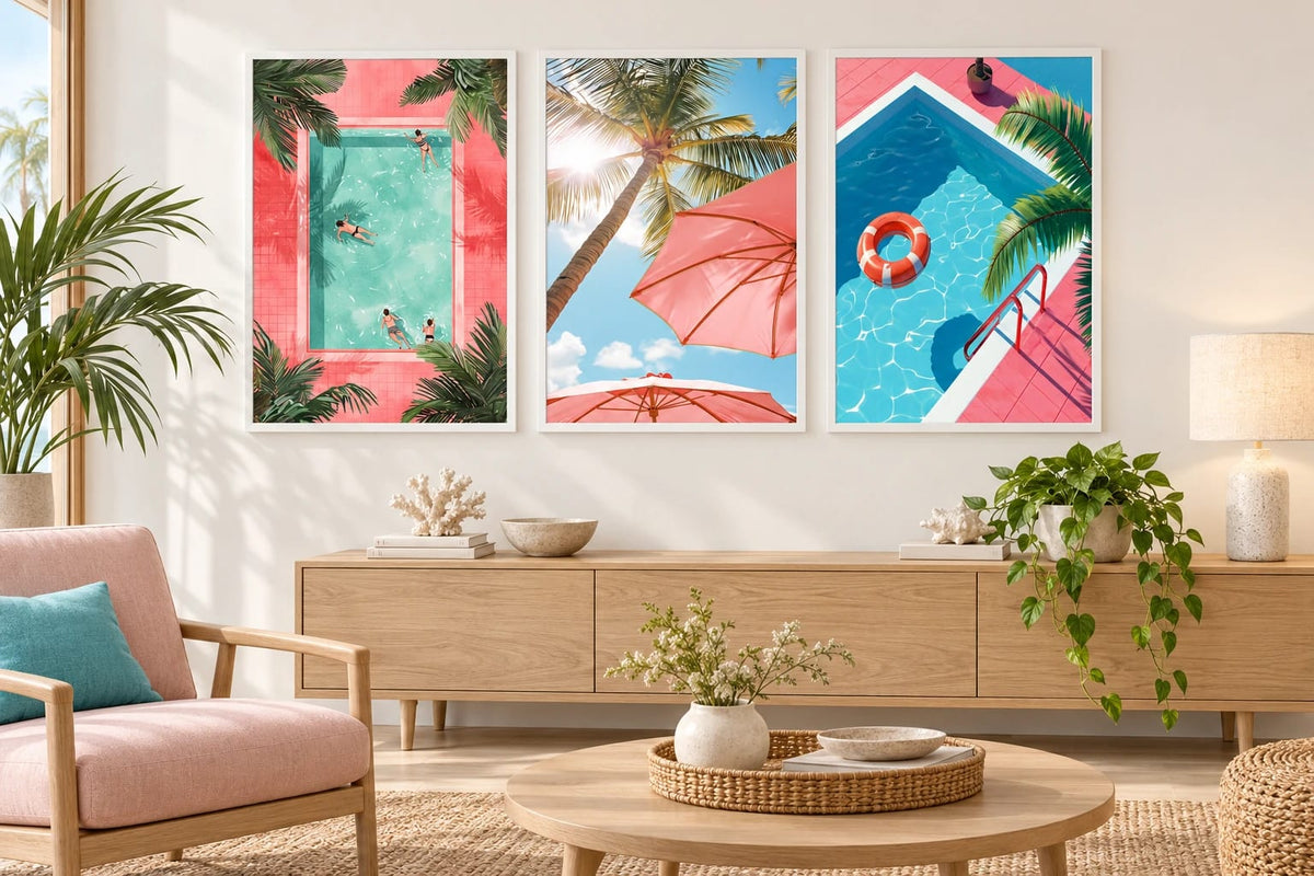 Pool and palm prints above a dresser near a pink chair.
