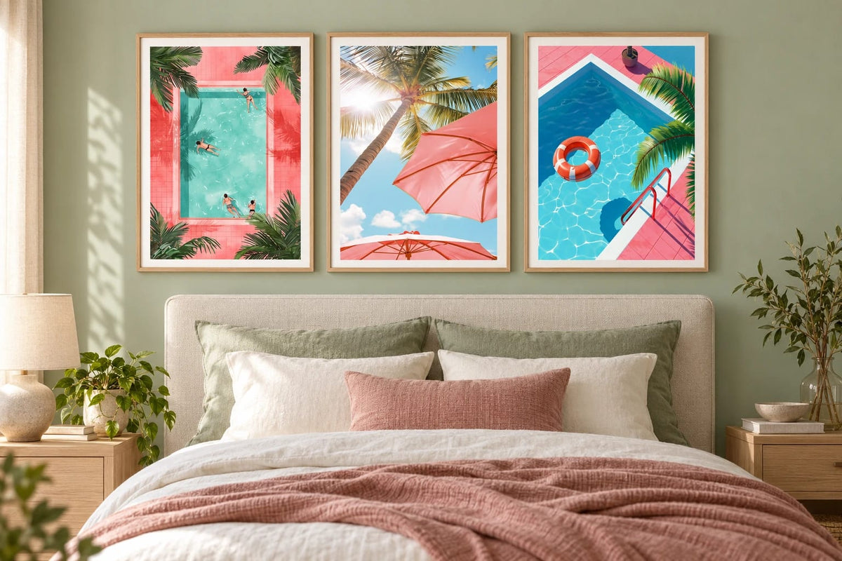 Poolside triptych above a bed with pink accents and sage wall.