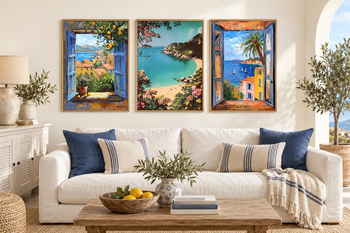Coastal prints above a sofa with blue pillows.