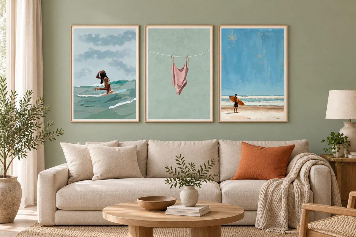 Coastal prints against a sage living room wall.