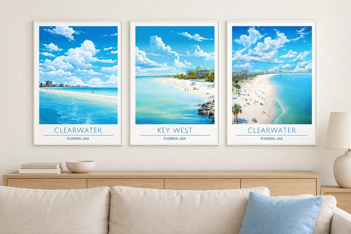 Blue beach prints above a light sofa.