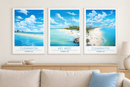 Blue beach prints above a light sofa.