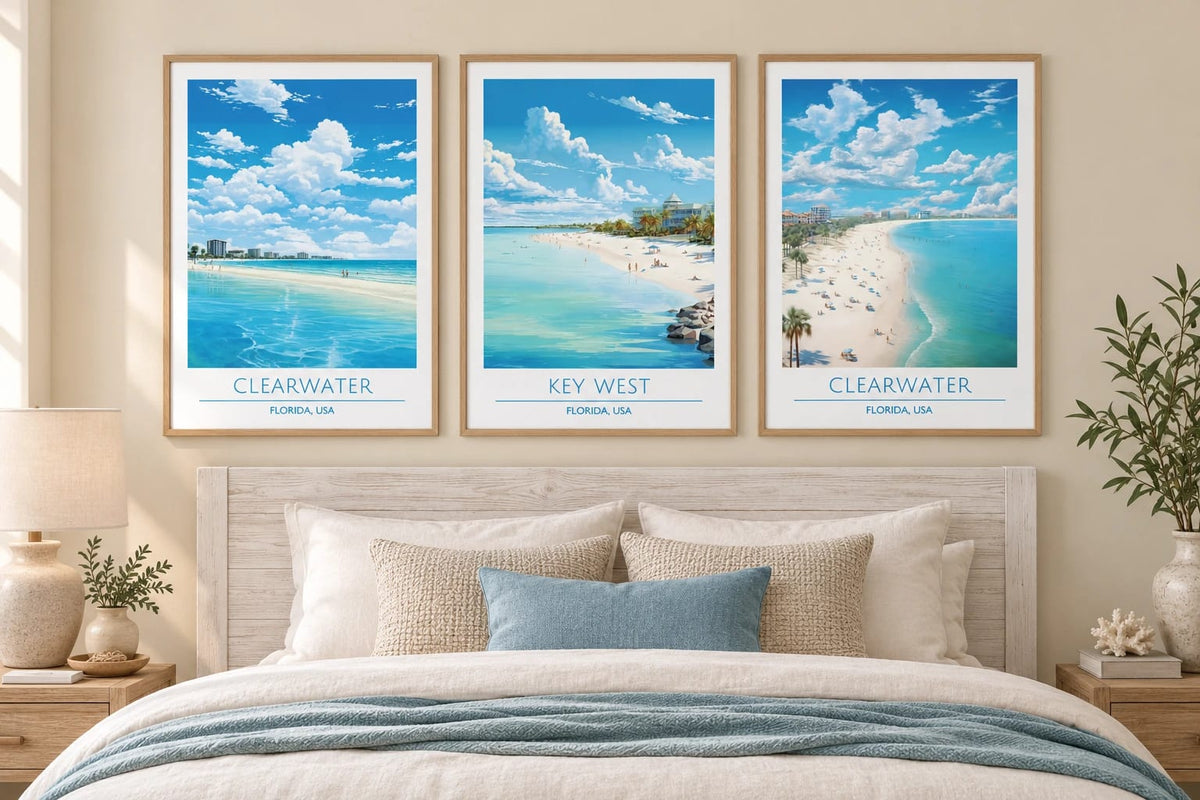 Three coastal prints above a bed in a bright bedroom.