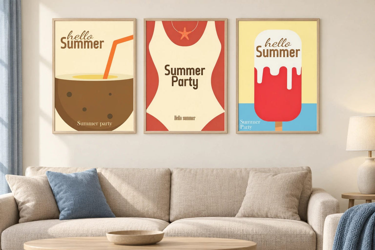 Three summer prints above a sofa with blue pillows.