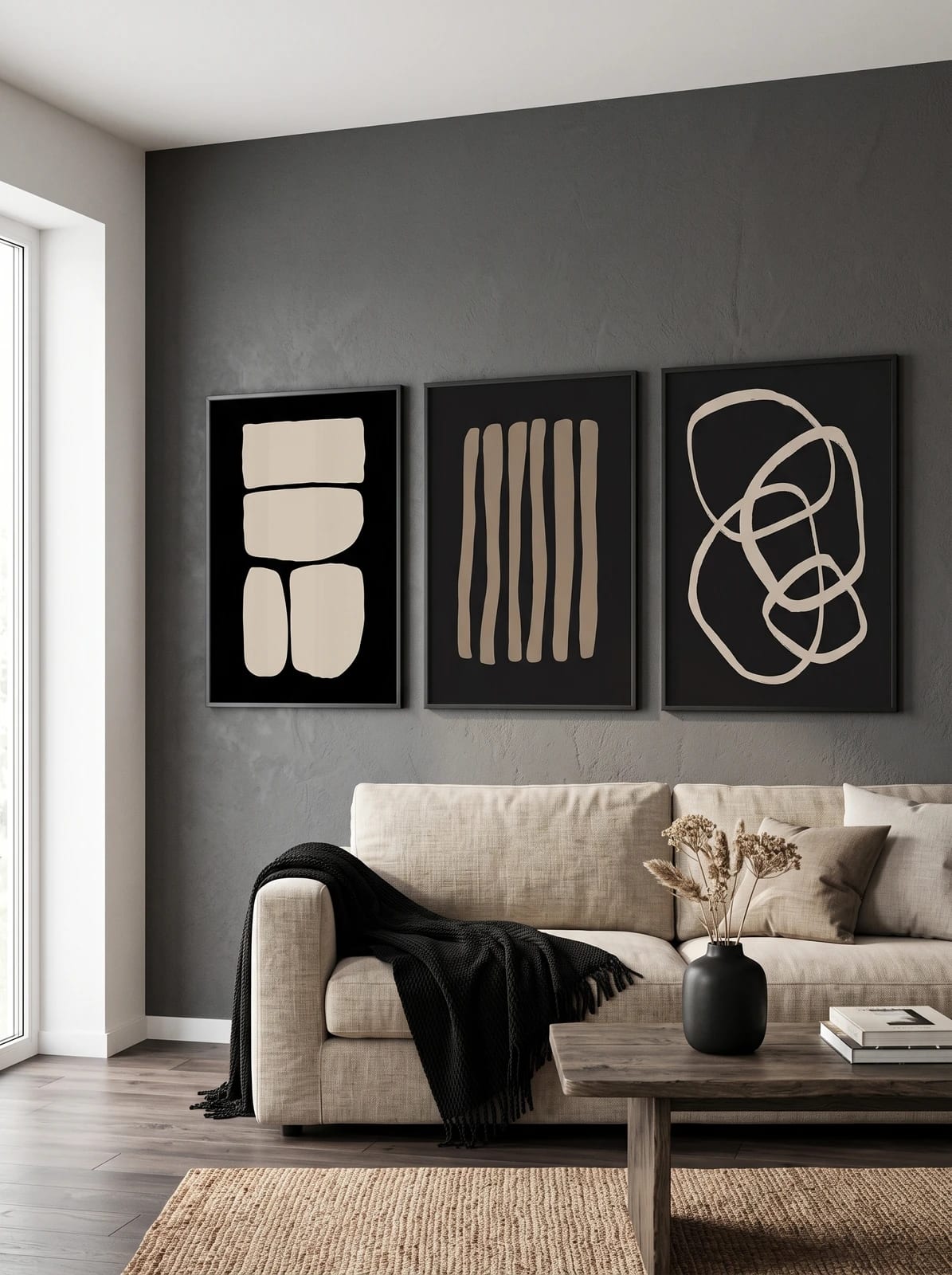 Three black and beige abstract prints grouped on a wall.