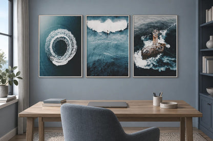 Three marine prints in a gray-blue office above a wood desk.