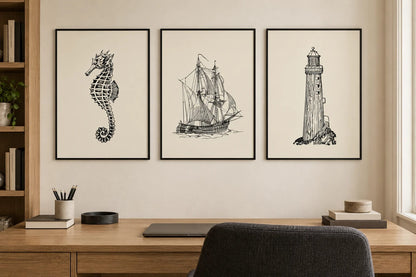 Seahorse, sailboat, and lighthouse prints in a home office.