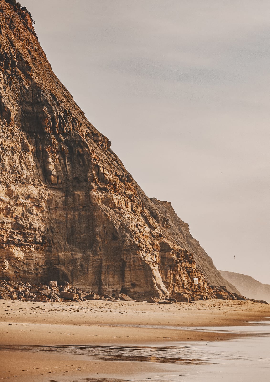 beach beneath high cliffs.