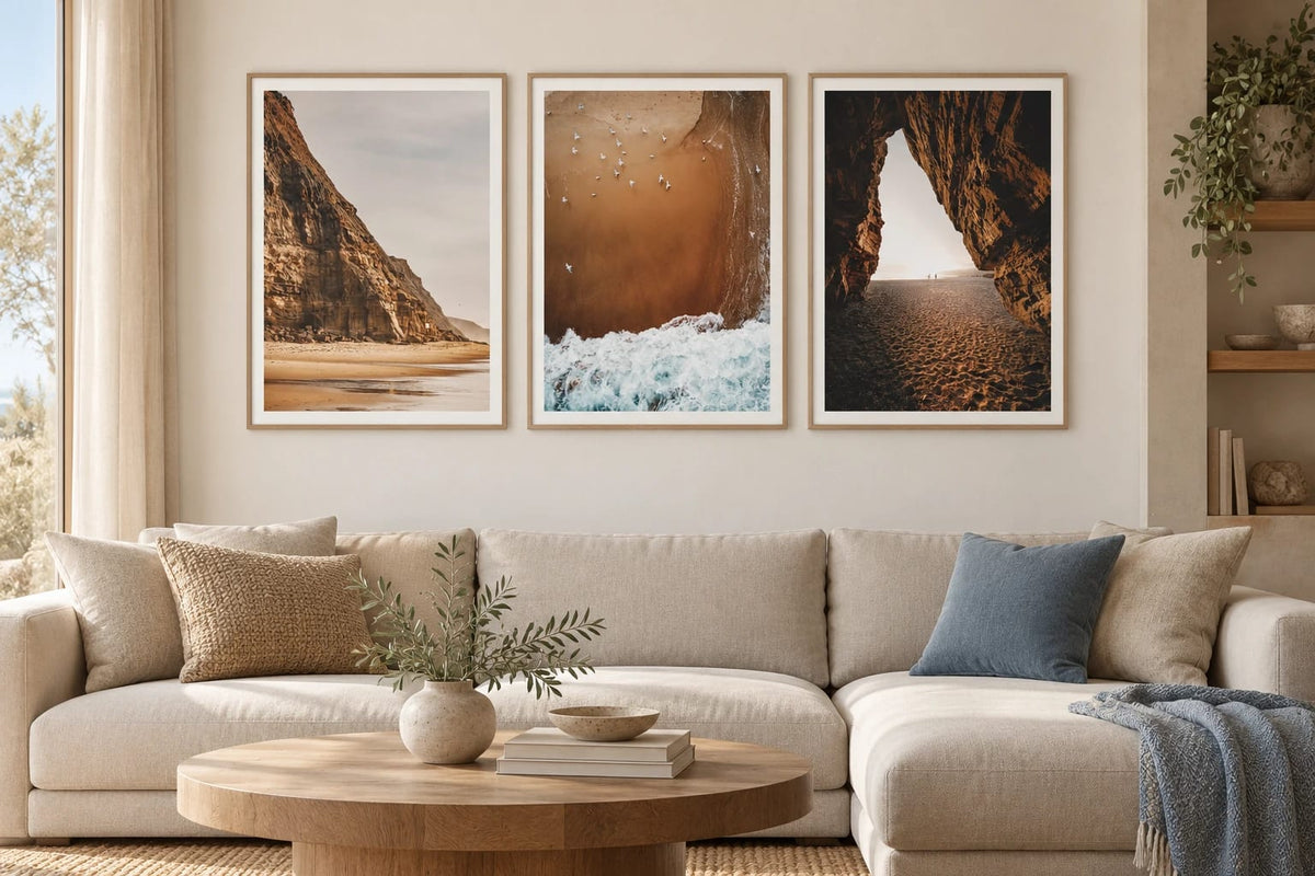 Coastal prints with cliffs and sea in a light living room.