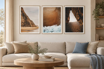 Coastal prints with cliffs and sea in a light living room.