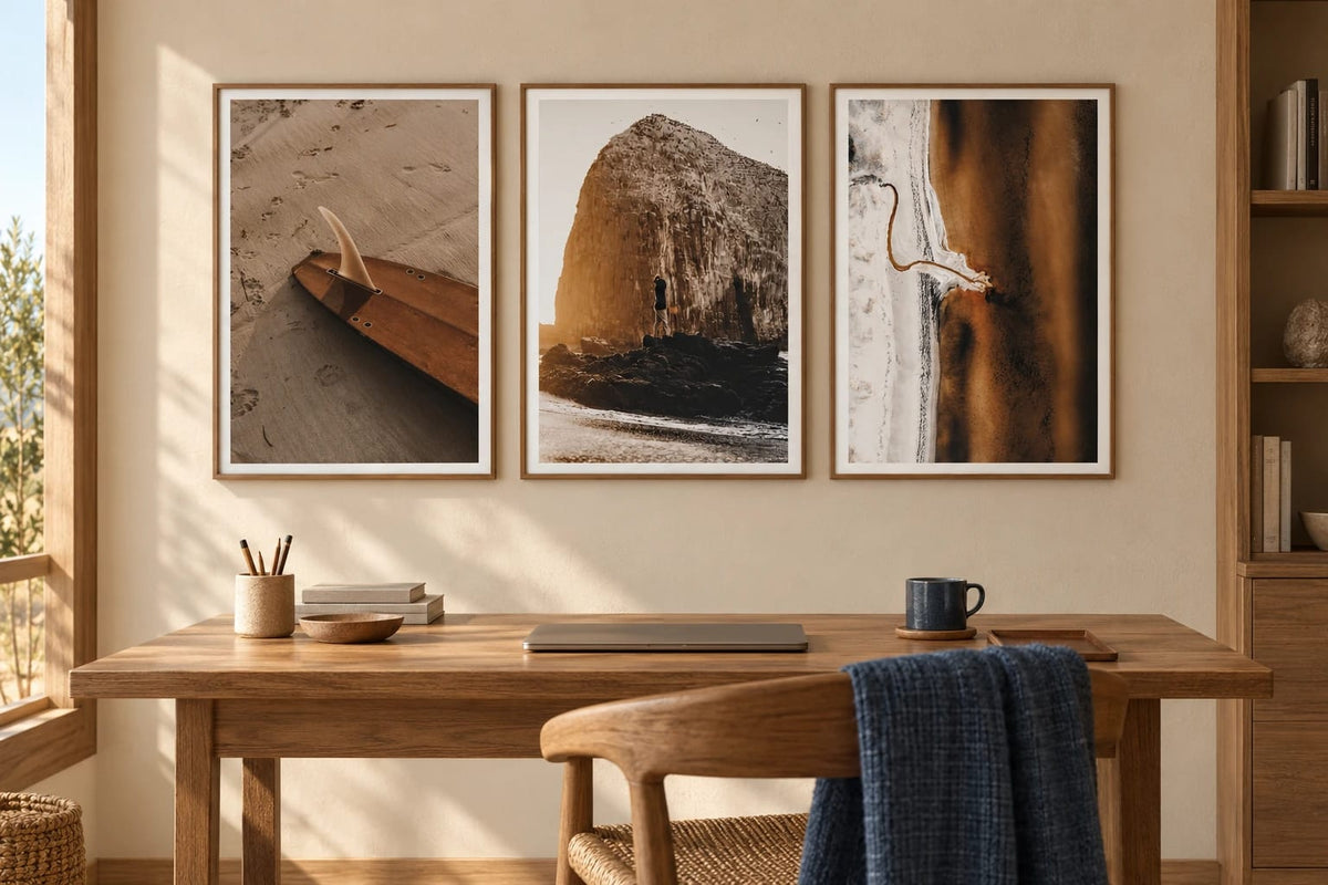 Surfboard, rock, and shore prints in a warm office.