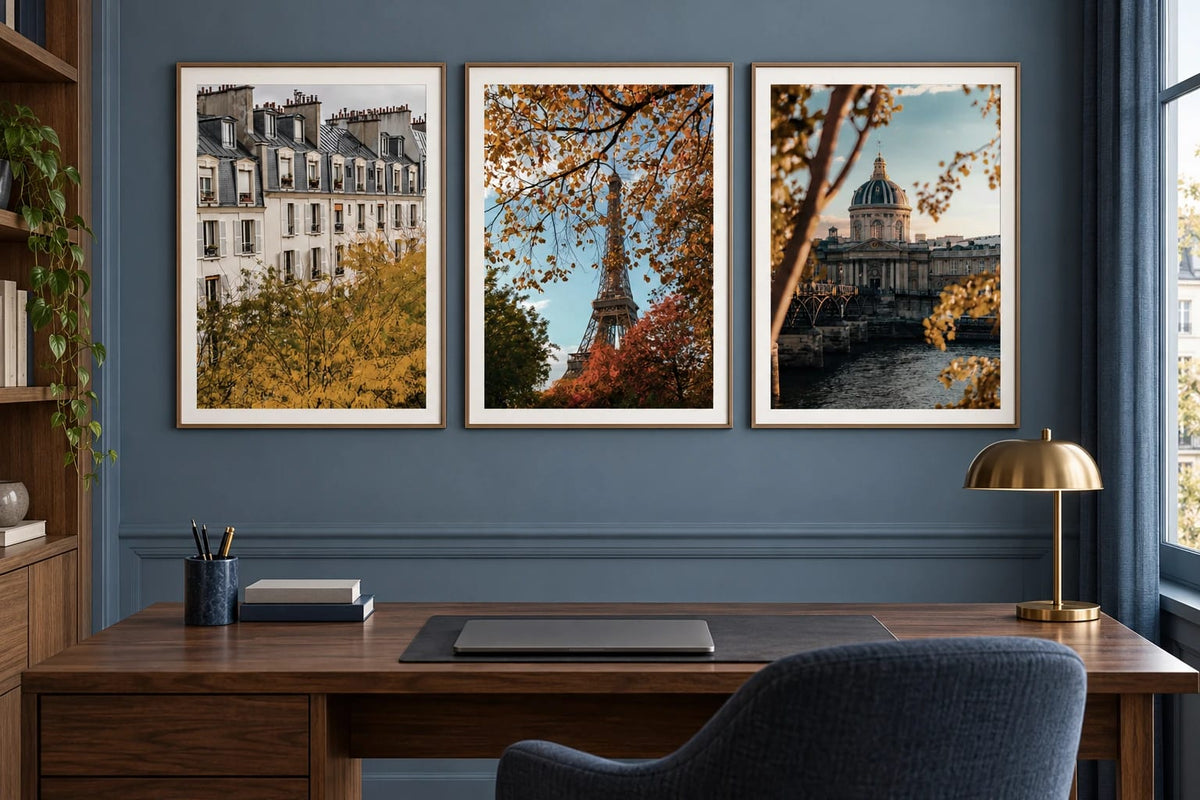 Three fall city views in a blue office with a wood desk.