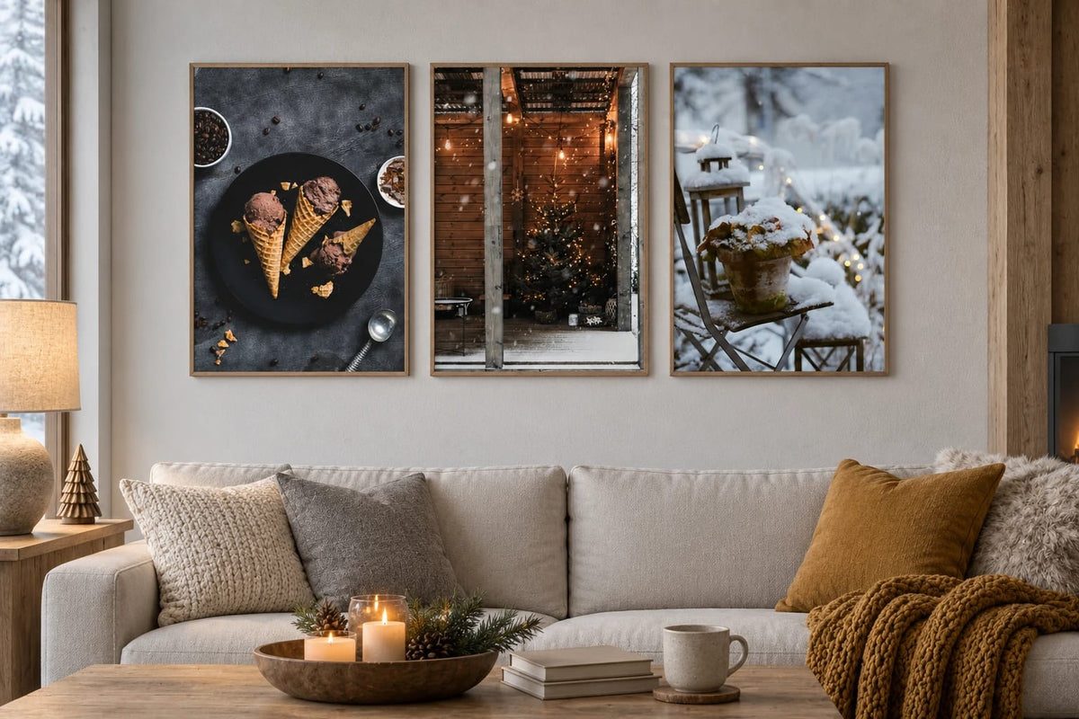 Three seasonal prints above a light sofa with a mustard throw.