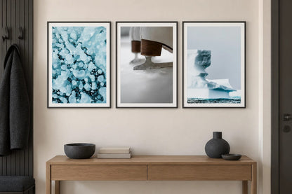 Three winter scenes hang above an oak console in an entryway.