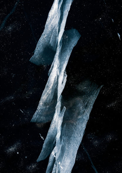 Clear angular ice fragments stand against a black background.