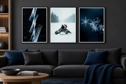 Three winter prints hang above a dark sofa.