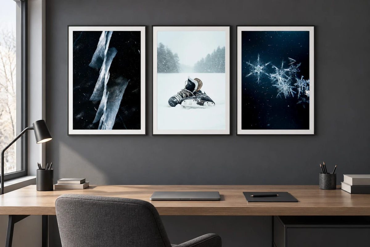 Ice, skates, and snowflake prints appear in an office with a gray wall and oak table.
