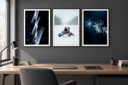 Ice, skates, and snowflake prints appear in an office with a gray wall and oak table.