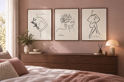 Figure and flower prints arranged in a softly toned bedroom.