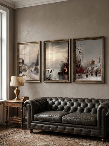 Three winter landscape prints grouped above a dark sofa.