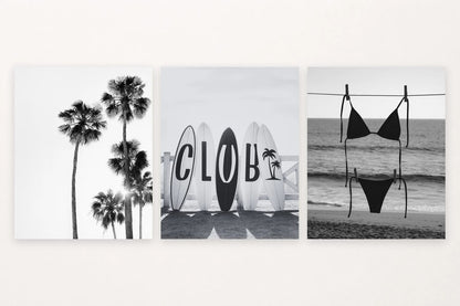 Three monochrome coastal prints show palm trees, surfboards, and a swimsuit near the shore.