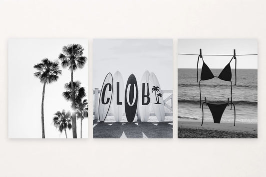 Three monochrome coastal prints show palm trees, surfboards, and a swimsuit near the shore.