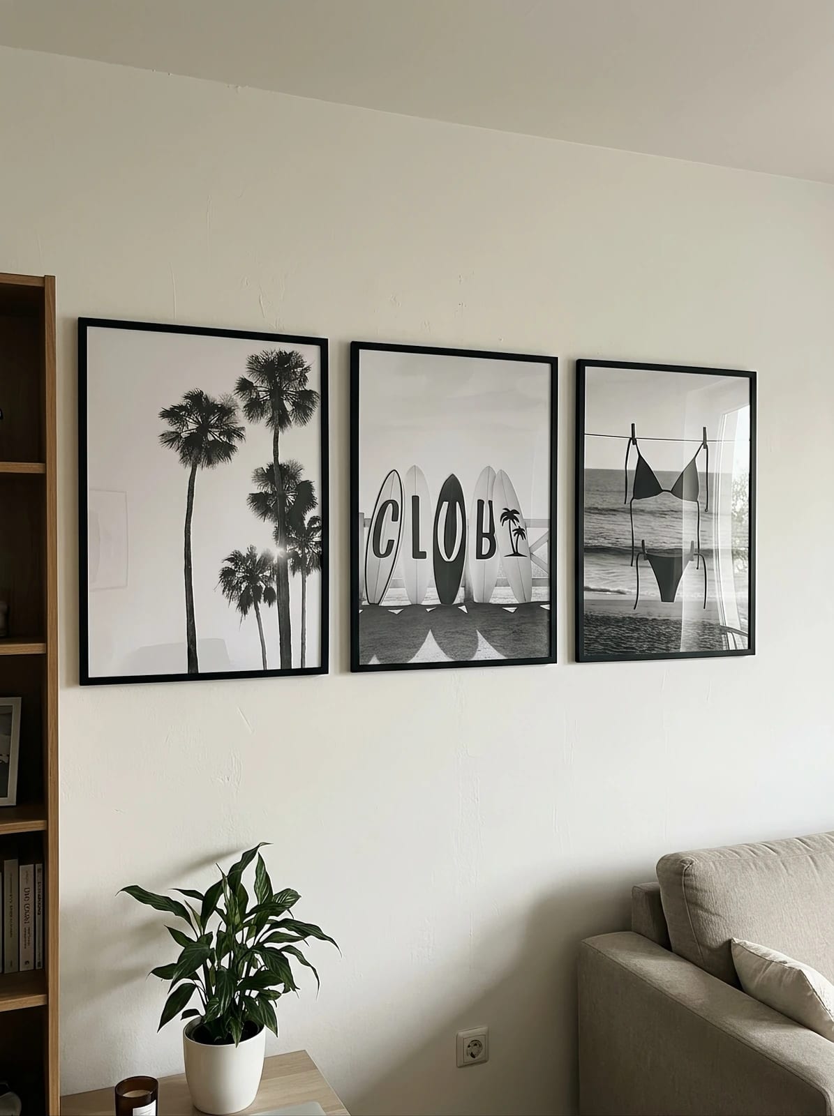 Palm trees, surfboards, and a swimsuit by the shore arranged as a set in a room; frames are not included.