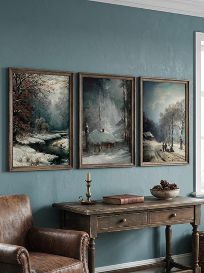 Three winter landscapes grouped above a console on a blue-green wall.
