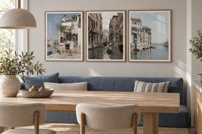 A cityscape print trio above a blue sofa.