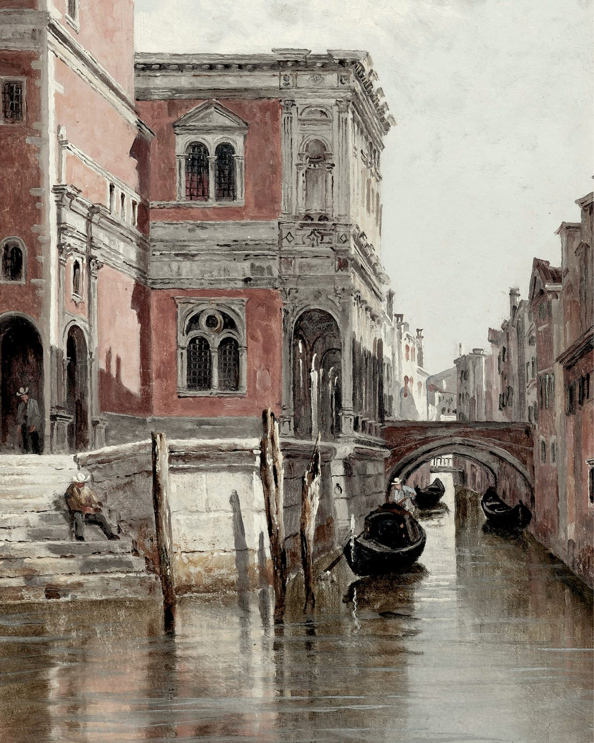 A reddish facade and bridge above a canal.