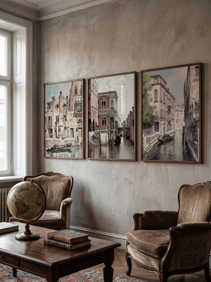 Three canal landscapes grouped on a gray-beige living room wall.