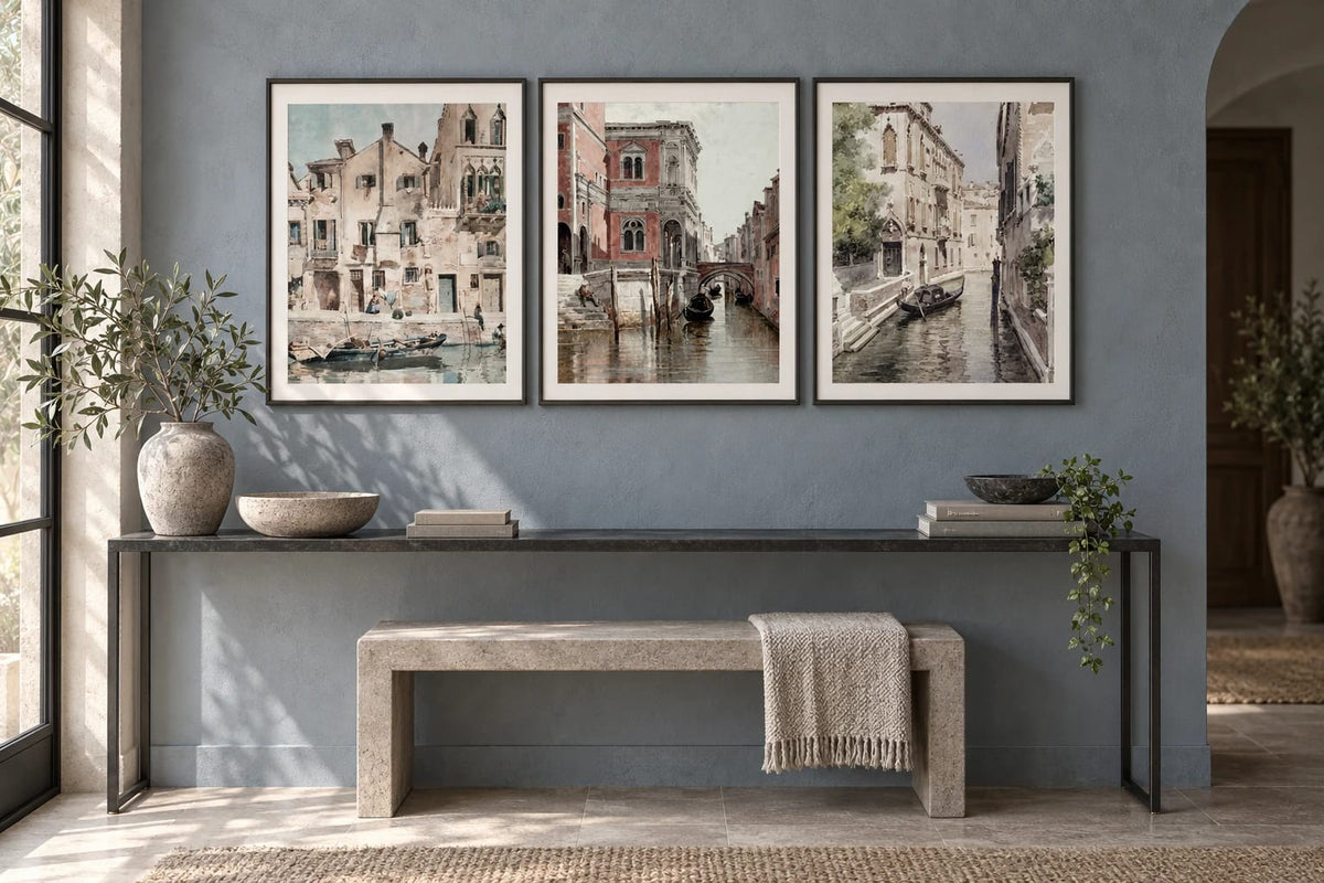 Canal prints arranged above a narrow console.