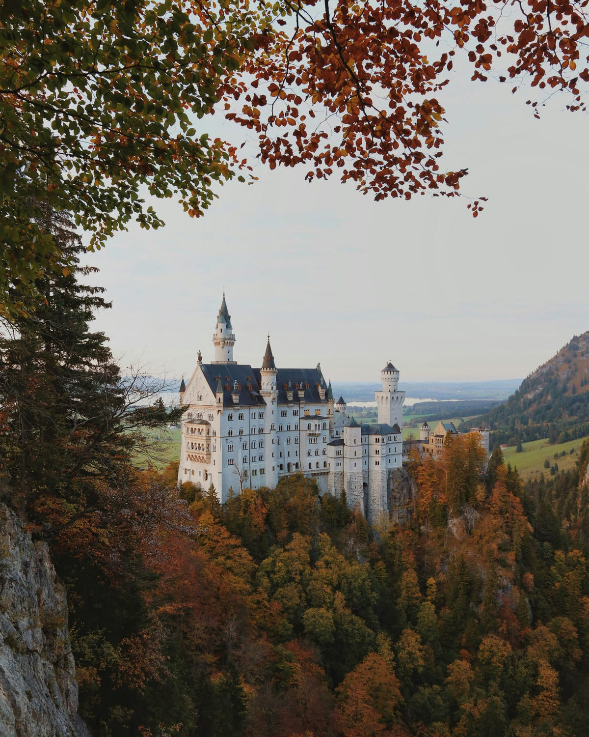 A stone castle among autumn trees.