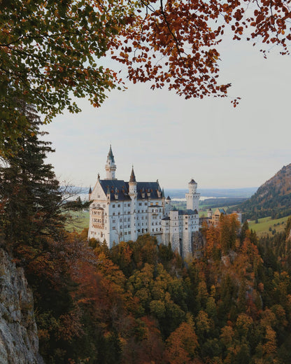 A stone castle among autumn trees.