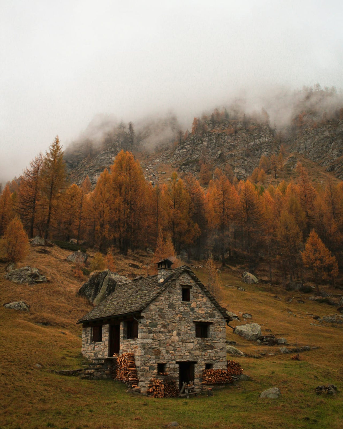 A stone cabin near misty mountains.