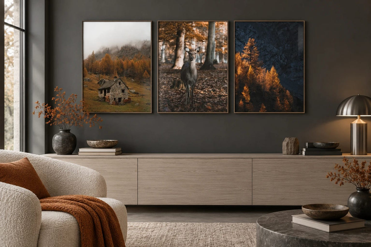 Mountain prints on a charcoal wall above a wood dresser.