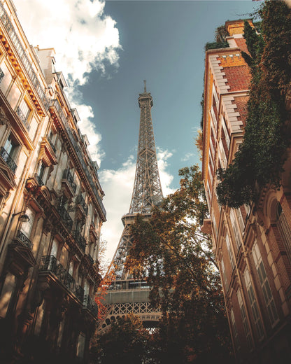 The Eiffel Tower between building facades.
