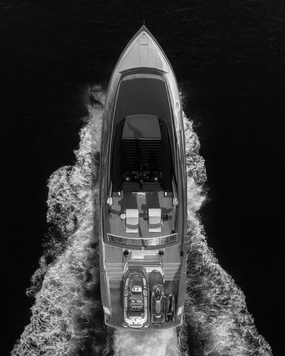 An overhead view of a motorboat and its wake.