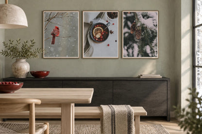 Red bird and evergreen prints above a dark sideboard.