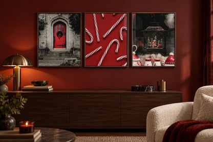 A red door and snow globe print set on a deep red wall.