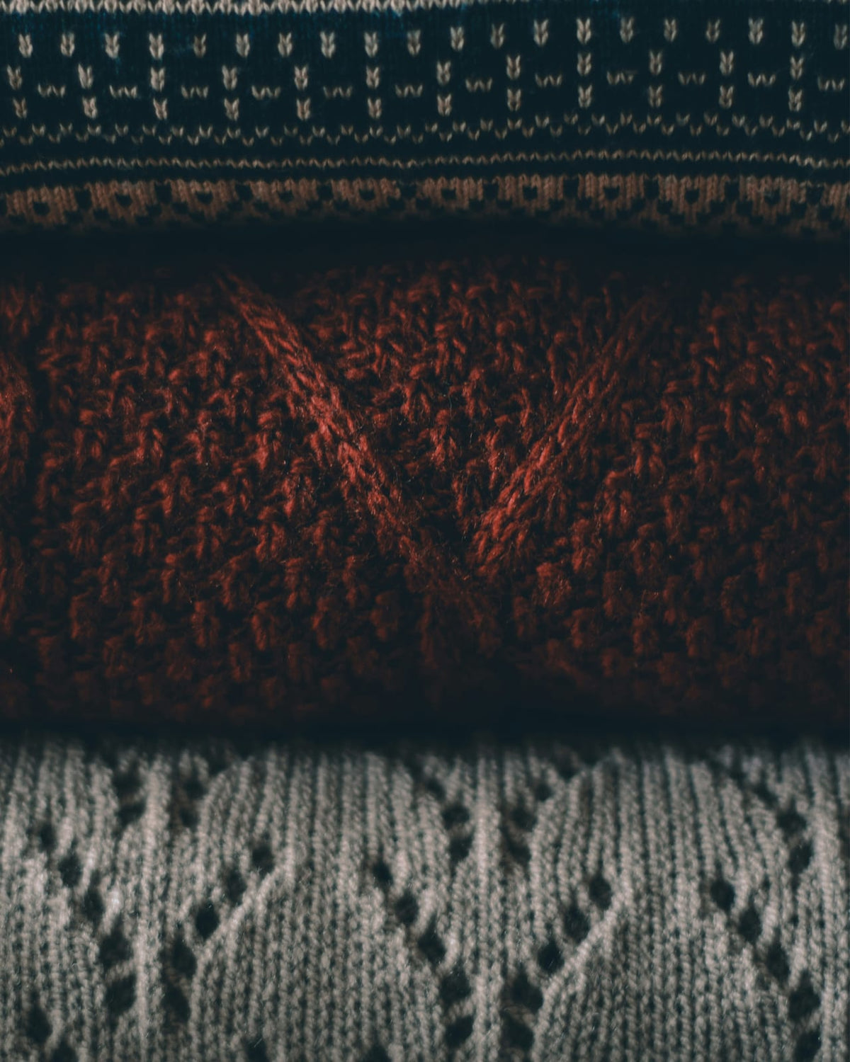 Rust, charcoal, and cream knit-like pattern.