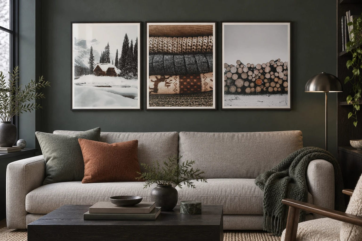 Cabin and texture prints above a sofa against a dark wall.