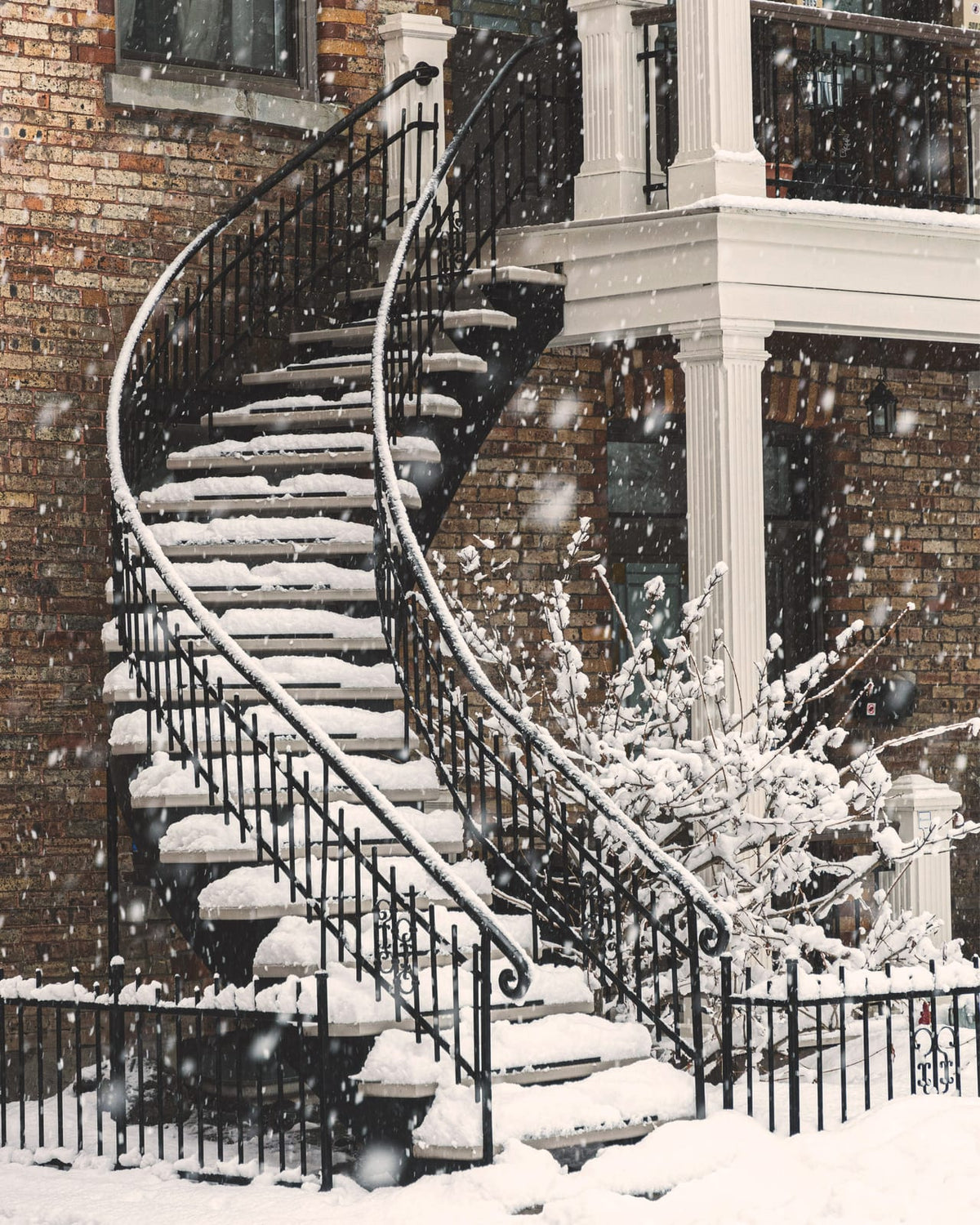 An outdoor staircase covered in snow.
